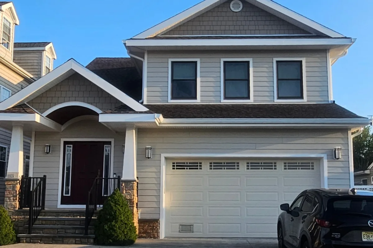 Sand-colored James Hardie siding and shingle gable accents on the front elevation of a Lanoka Harbor, NJ home