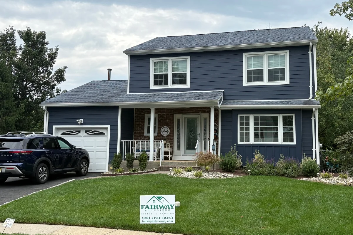 Navy blue James Hardie lap siding and white trim on the front elevation of a South Brunswick, NJ colonial