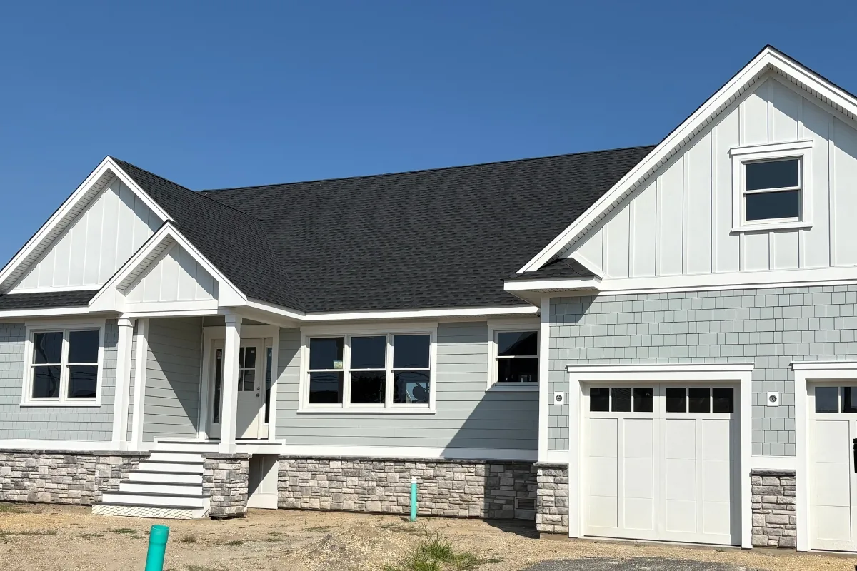 James Hardie lap siding, board-and-batten, and shingle accents at the entry and garage of a Forked River, NJ new build